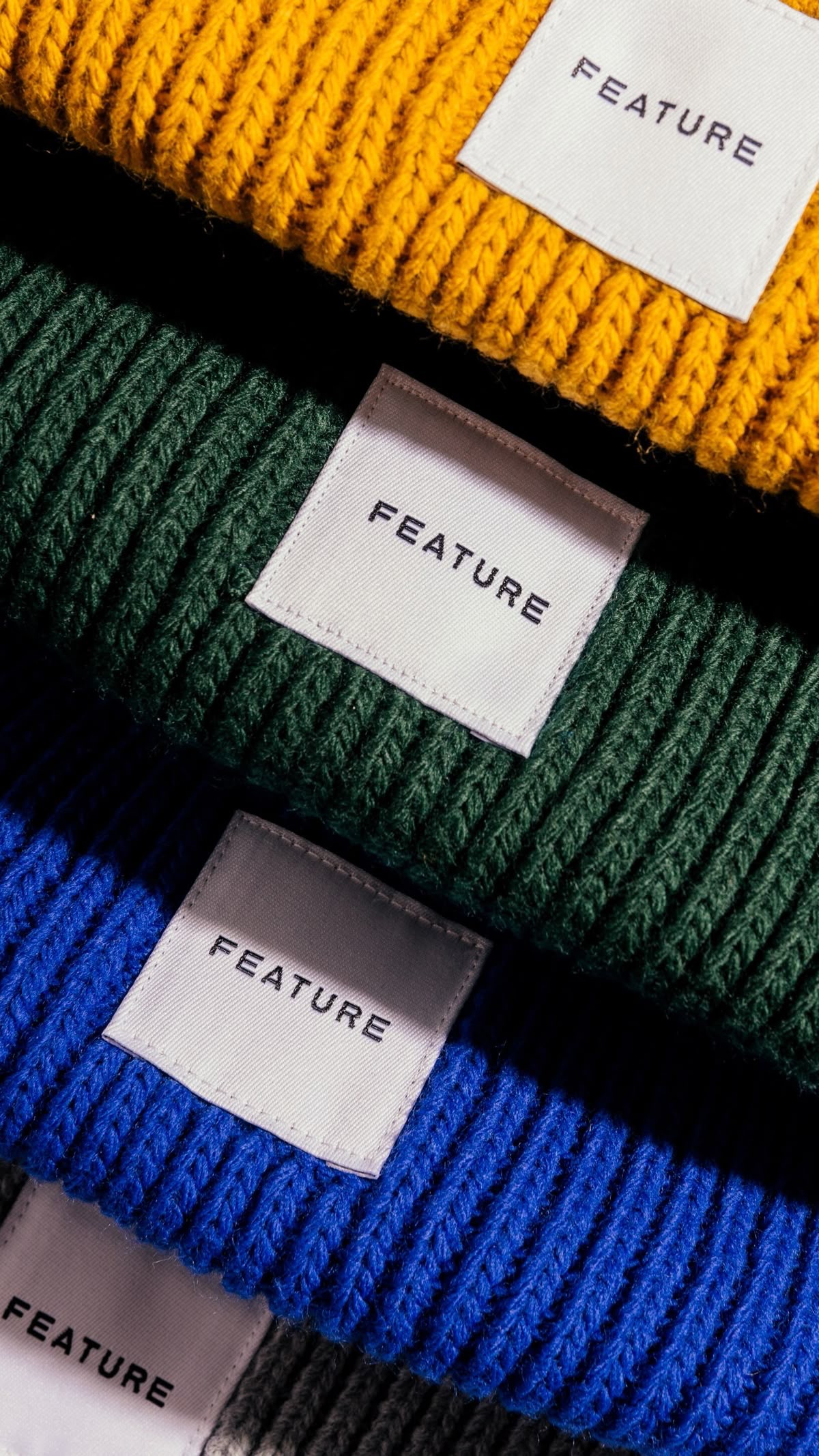 Branded knit beanies with custom woven labels